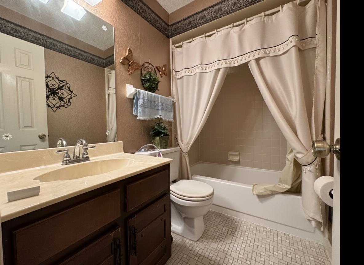 4574 Ross Road Memphis, TN 38141 - Photo 14 of 15 a bathroom with a sink a toilet a mirror and shower