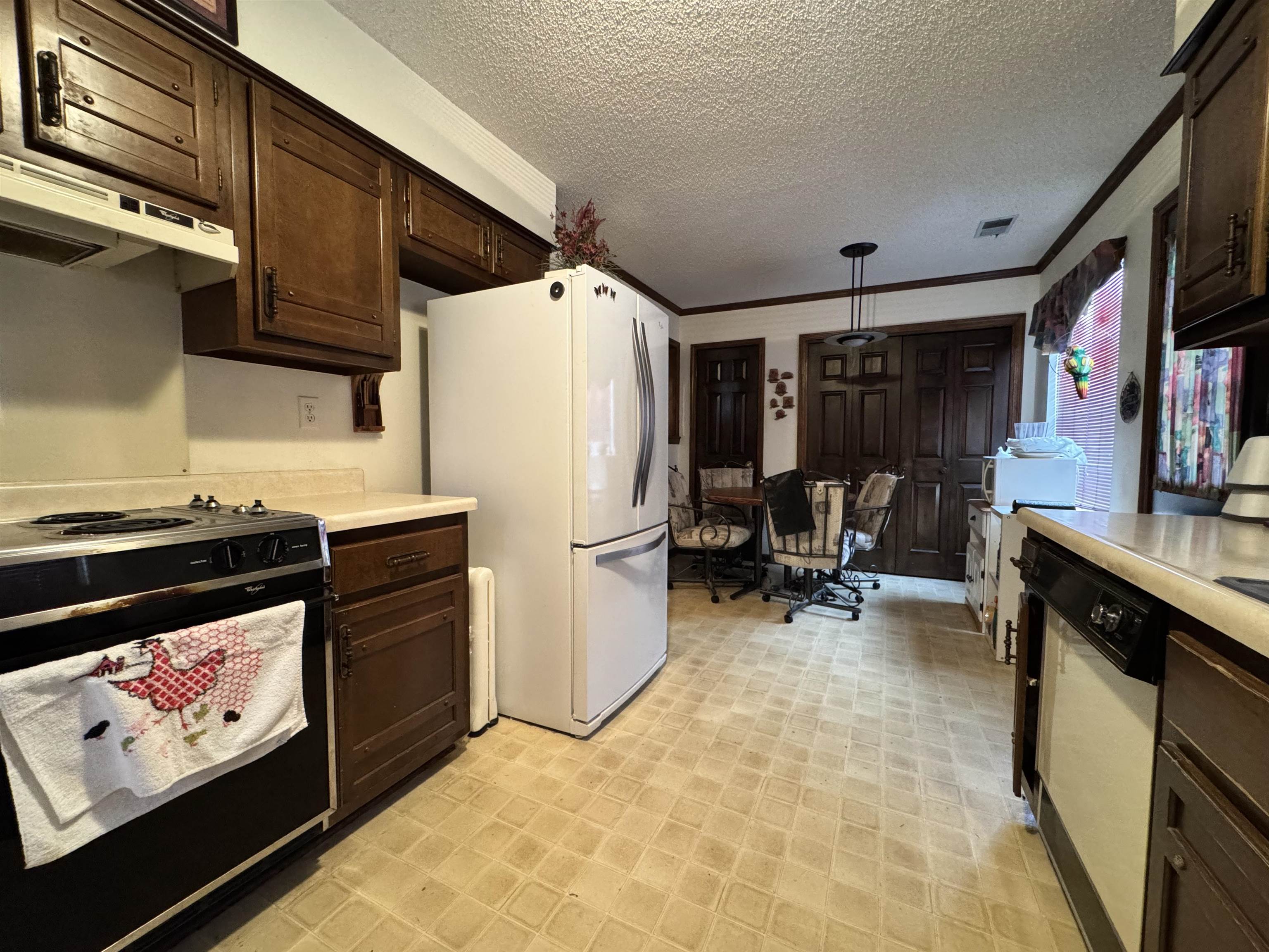 4574 Ross Road Memphis, TN 38141 - Photo 3 of 15 a kitchen with refrigerator and cabinets