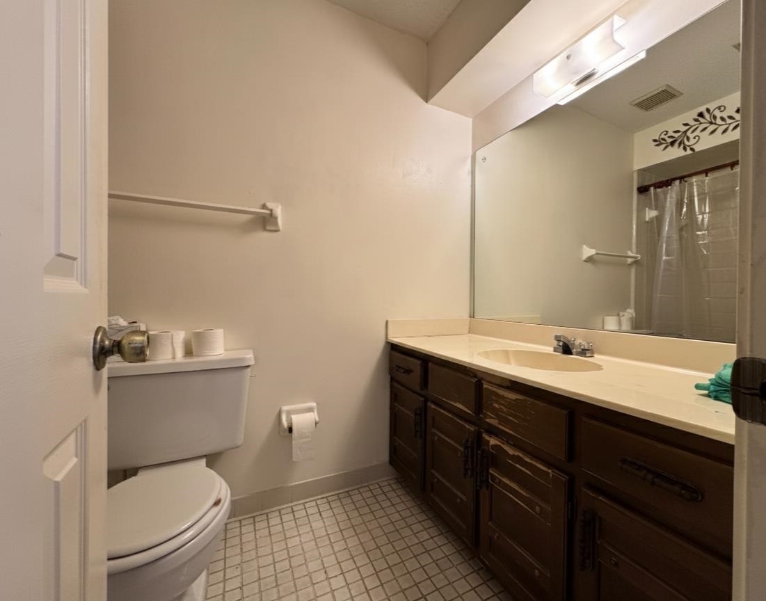 4574 Ross Road Memphis, TN 38141 - Photo 10 of 15 a bathroom with a toilet a sink and mirror