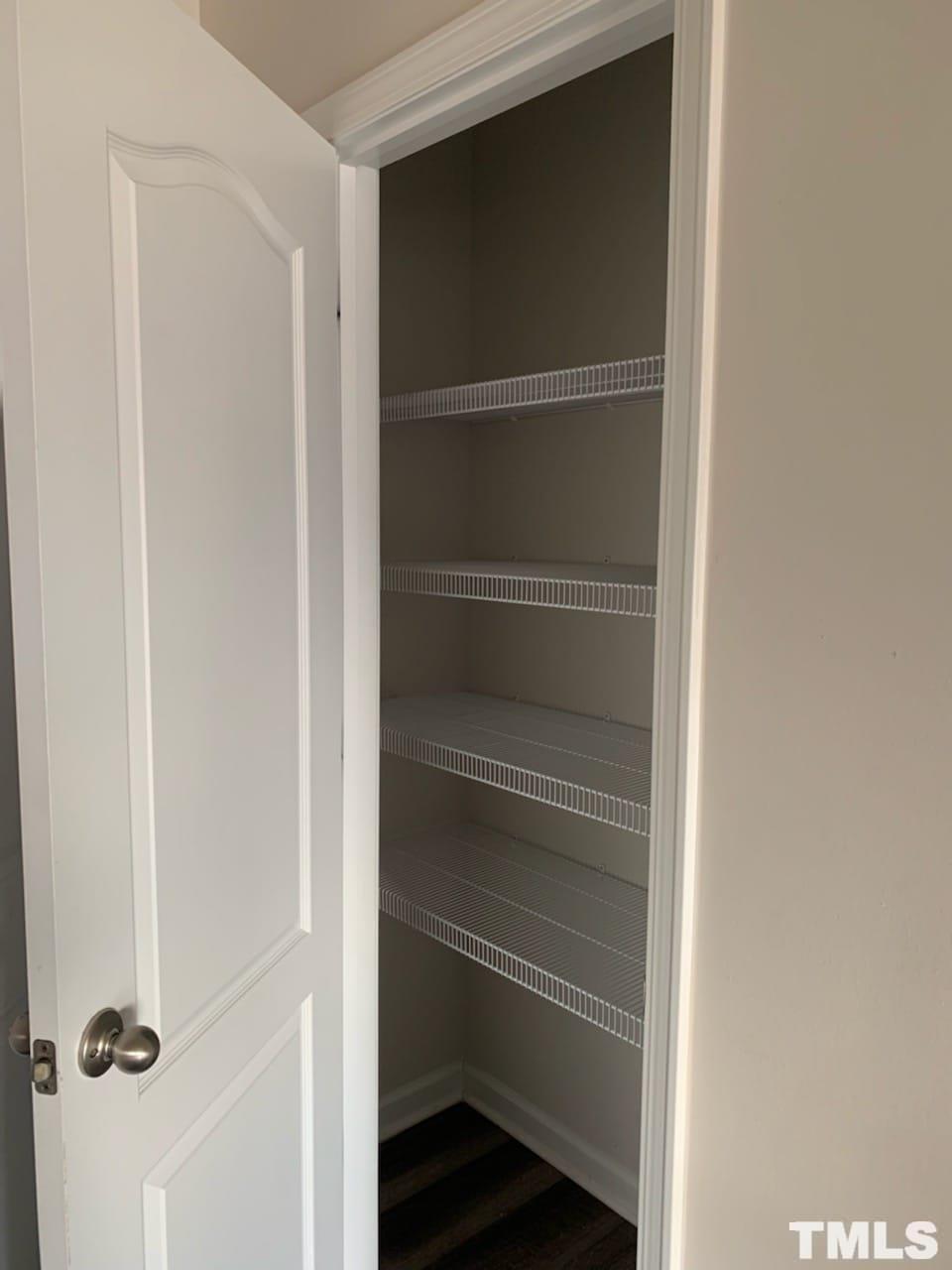 3413 Dropseed Drive Apex, NC 27502 - Photo 15 of 23 a view of walk in closet with empty racks