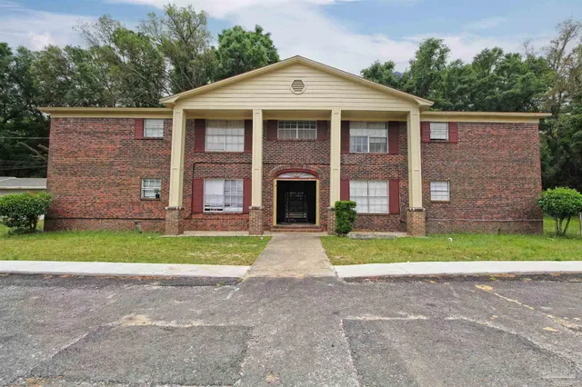 a front view of a house with a yard and a garage