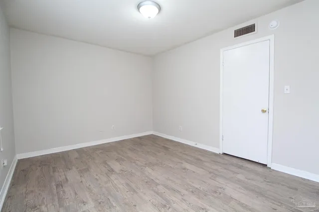 an empty room with wooden floor