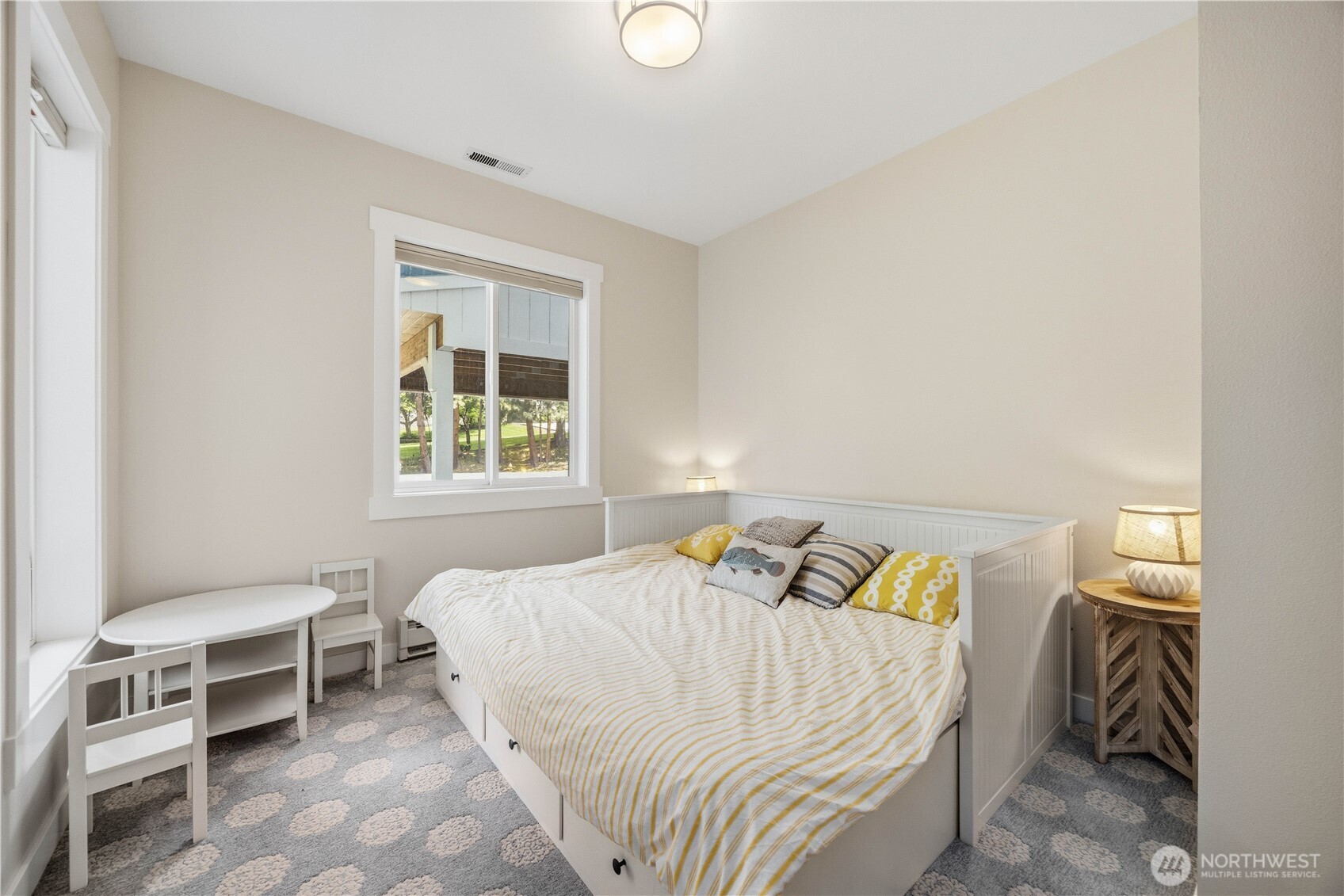 141 Sunset Place Manson, WA 98831 - Photo 23 of 38 a bed sitting in a bedroom next to a window