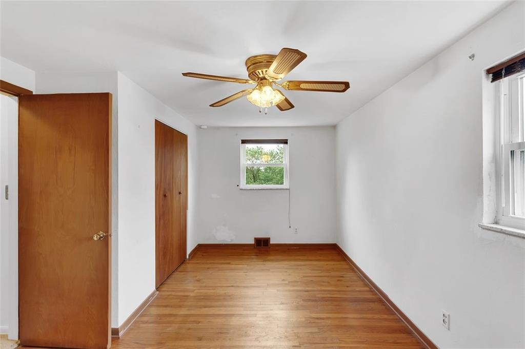 320 Center New Texas Road Pittsburgh, PA 15239 - Photo 14 of 25 a view of a big room with wooden floor chandelier fan and windows