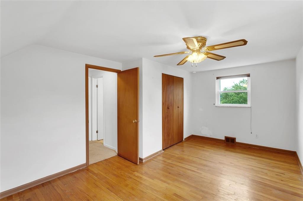 320 Center New Texas Road Pittsburgh, PA 15239 - Photo 16 of 25 a view of a big room with wooden floor and a chandelier fan