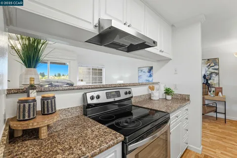 a kitchen with a stove a sink and a refrigerator