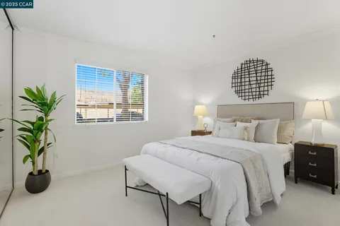 a bedroom with a bed and potted plant