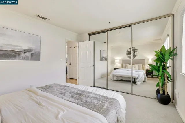 a bedroom with a bed and a large window