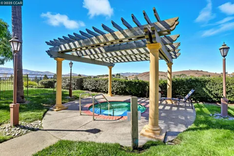 a view of a patio with a table chairs and a backyard