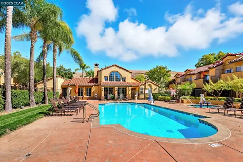 a view of a house with swimming pool and sitting area