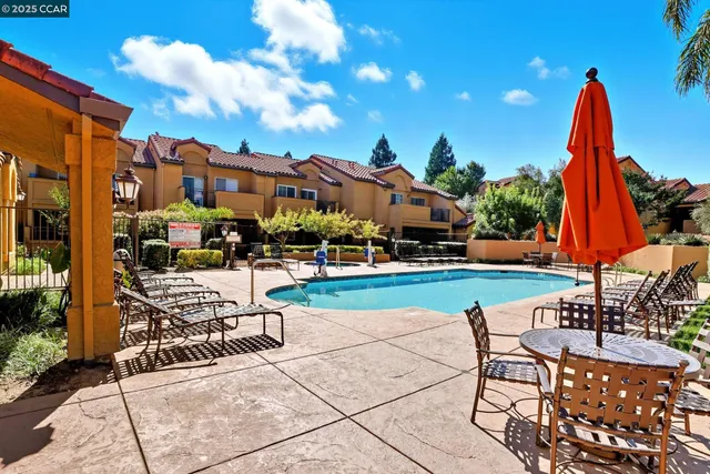 a view of a patio with a table and chairs