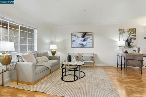 a living room with furniture a rug and a lamp