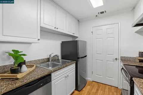 a kitchen with sink and cabinets