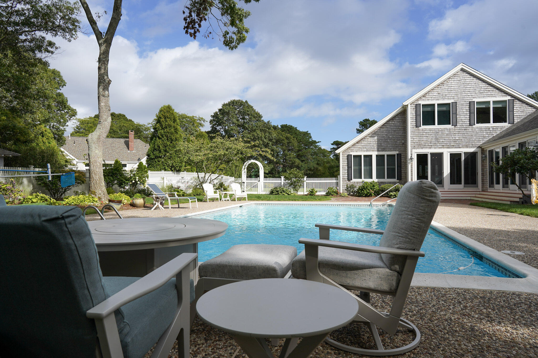 14 Shoestring Bay Road Mashpee, MA 02649 - Photo 8 of 66 a view of a chair and table in the backyard