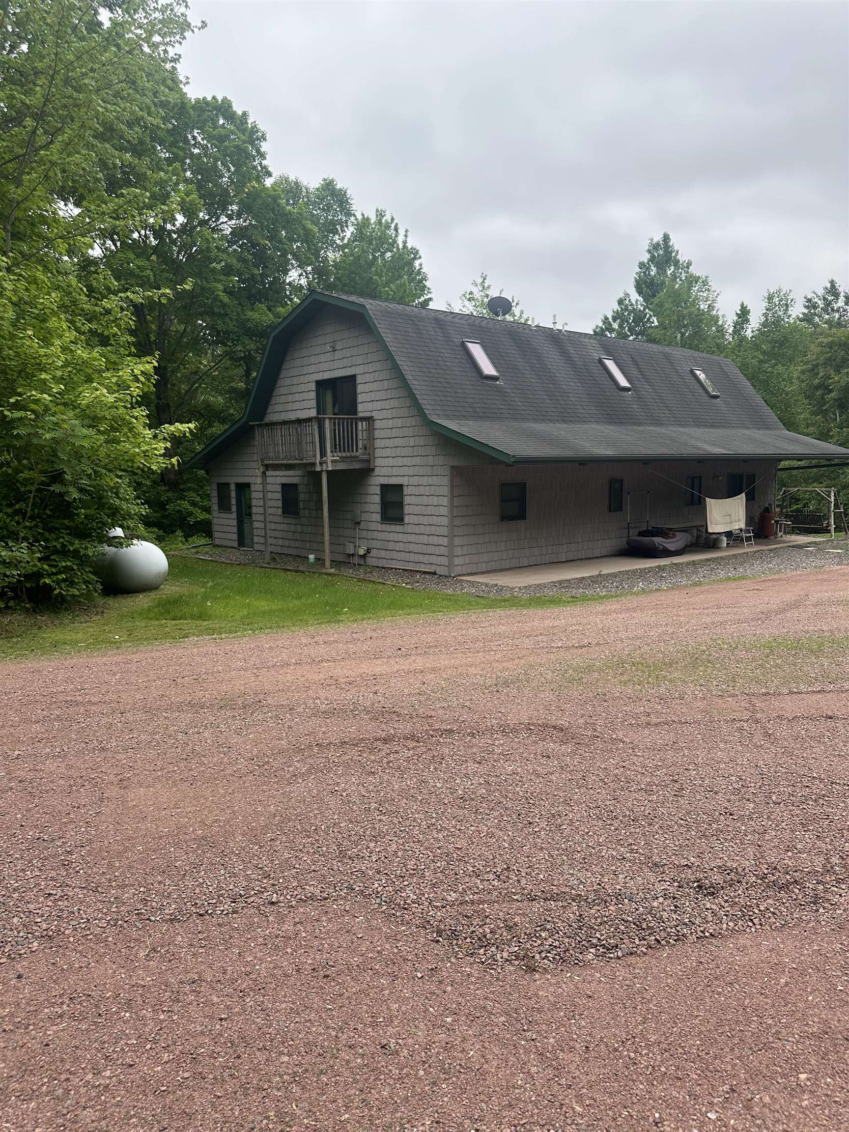58875 Roy Anderson Road Mason, WI 54856 - Photo 1 of 26 View of property exterior with dirt driveway, a carport, and a gambrel roof