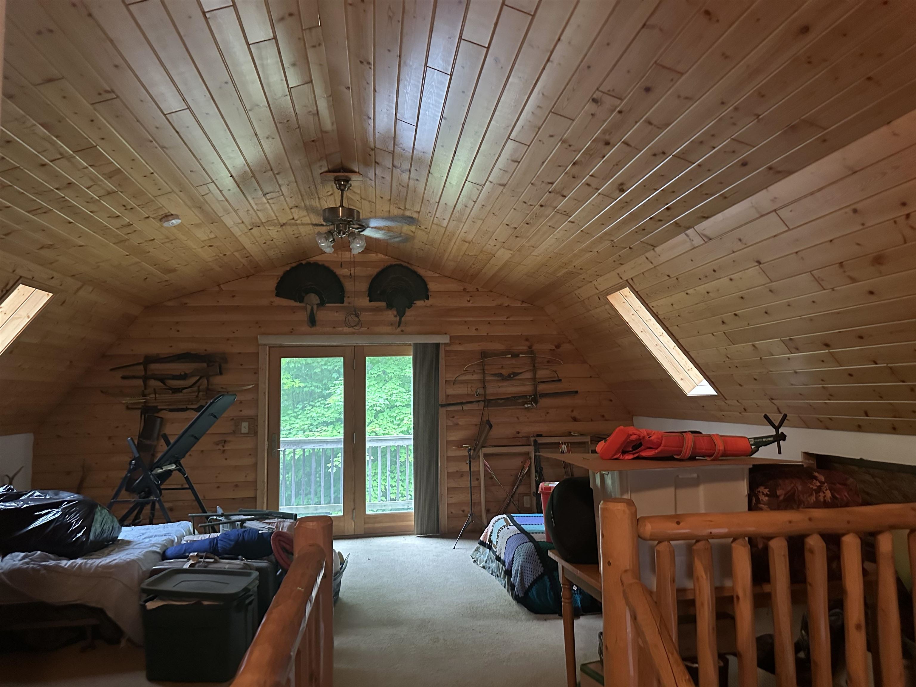 58875 Roy Anderson Road Mason, WI 54856 - Photo 16 of 26 Bedroom with carpet floors, vaulted ceiling, wood ceiling, access to outside, and a skylight