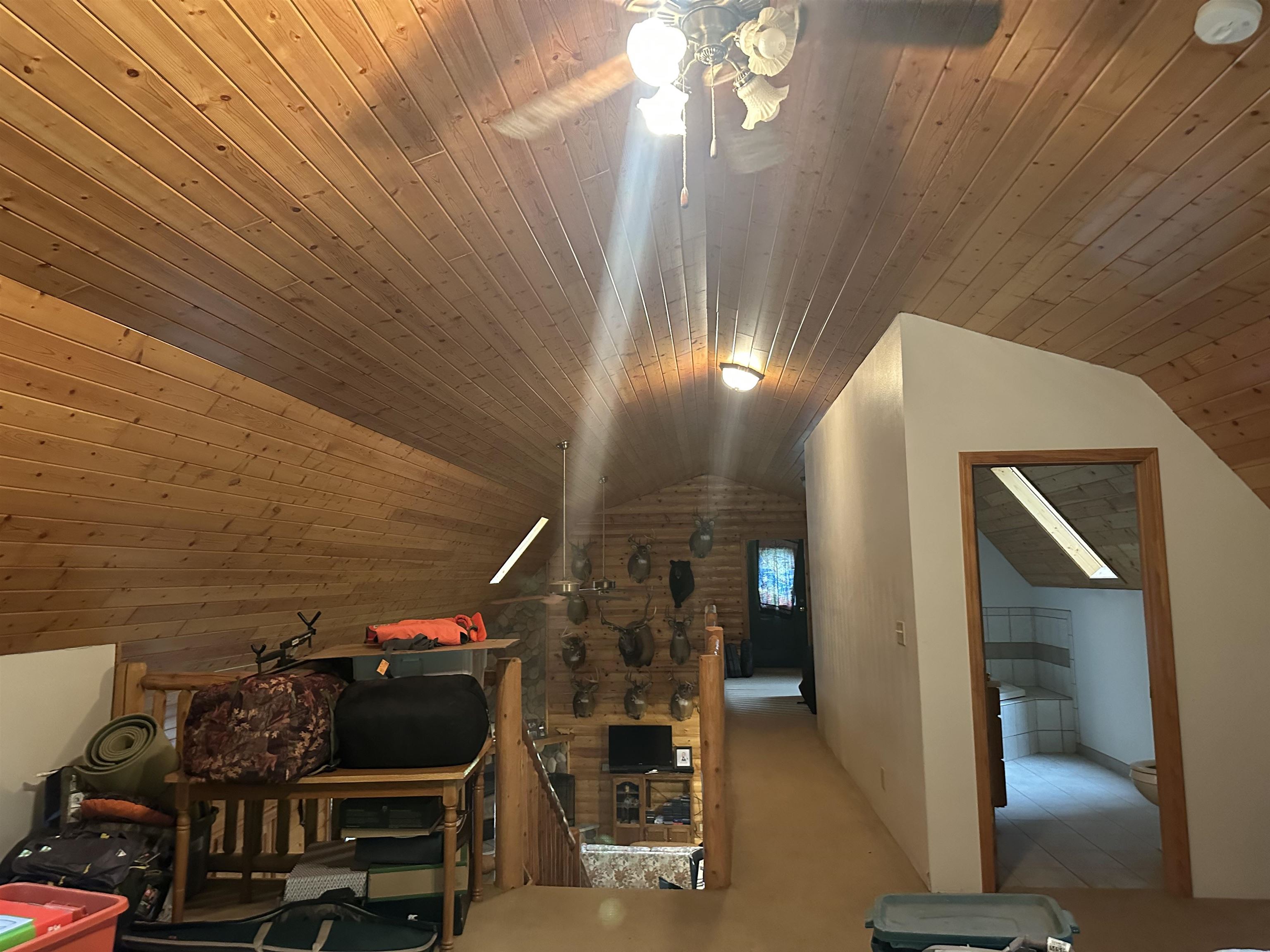 58875 Roy Anderson Road Mason, WI 54856 - Photo 18 of 26 Additional living space with vaulted ceiling, ceiling fan, wooden ceiling, and carpet floors