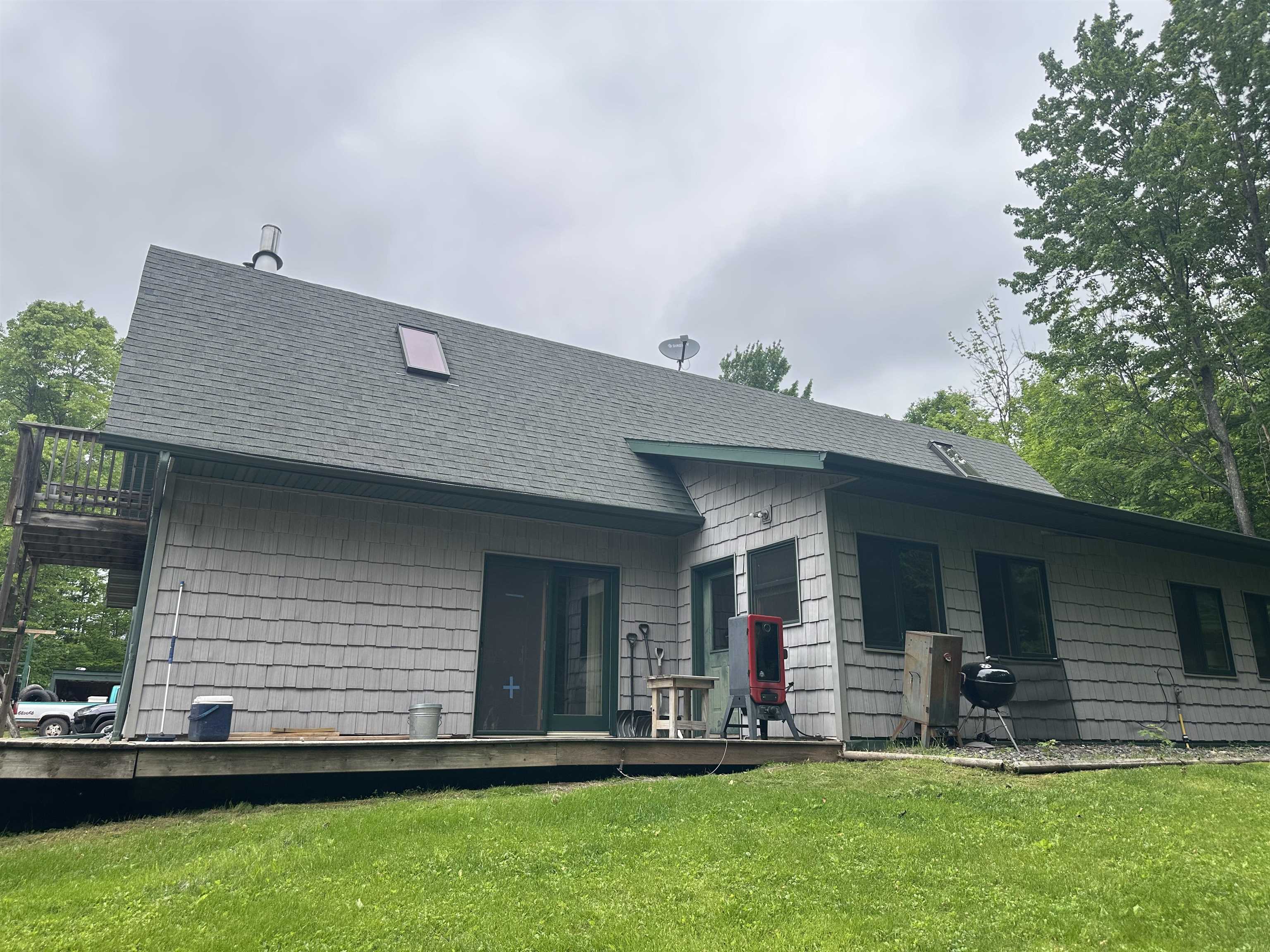 58875 Roy Anderson Road Mason, WI 54856 - Photo 26 of 26 Rear view of property featuring a lawn, roof with shingles, and a balcony