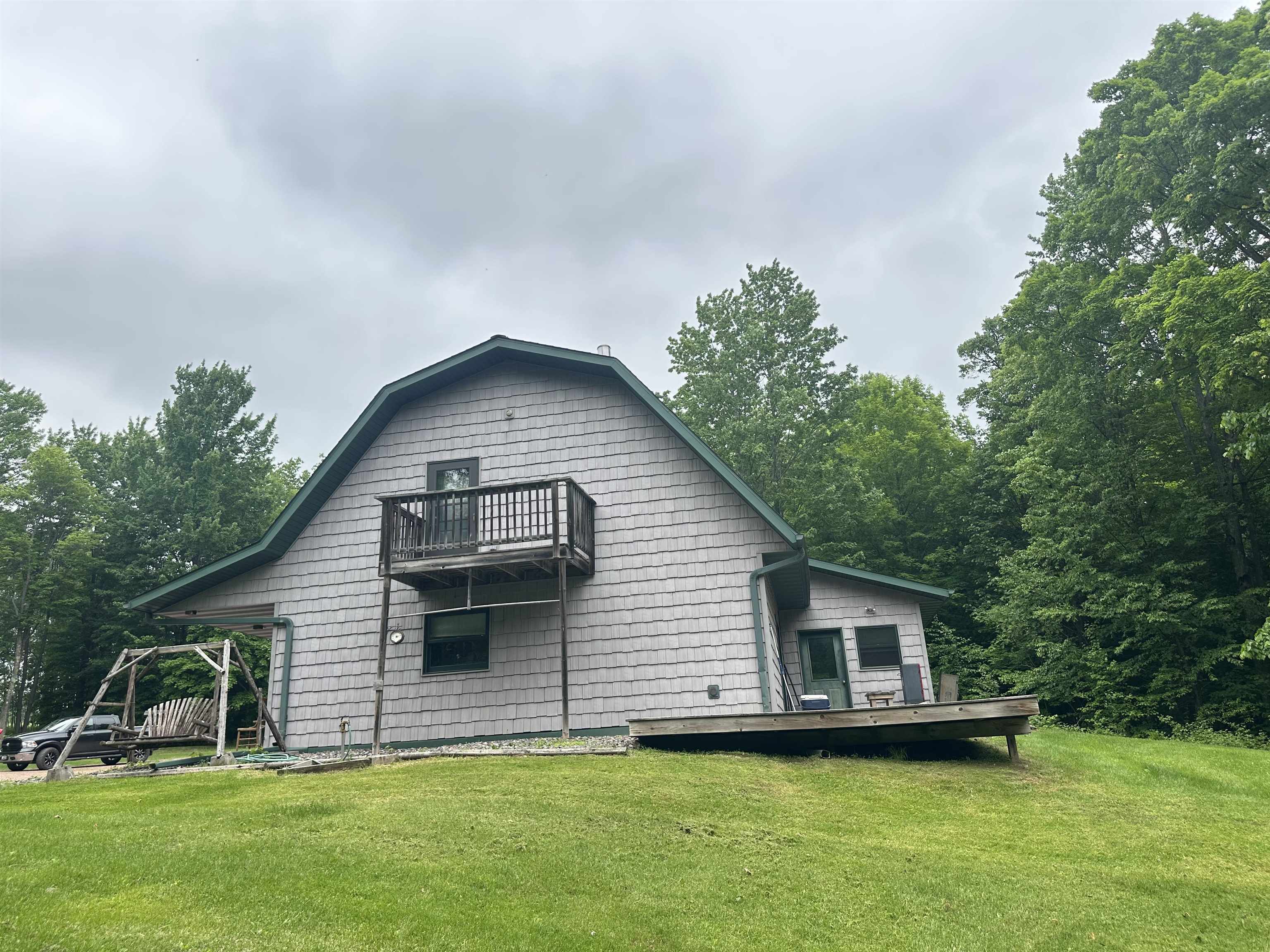 58875 Roy Anderson Road Mason, WI 54856 - Photo 3 of 26 Back of house with a balcony, a lawn, and a deck