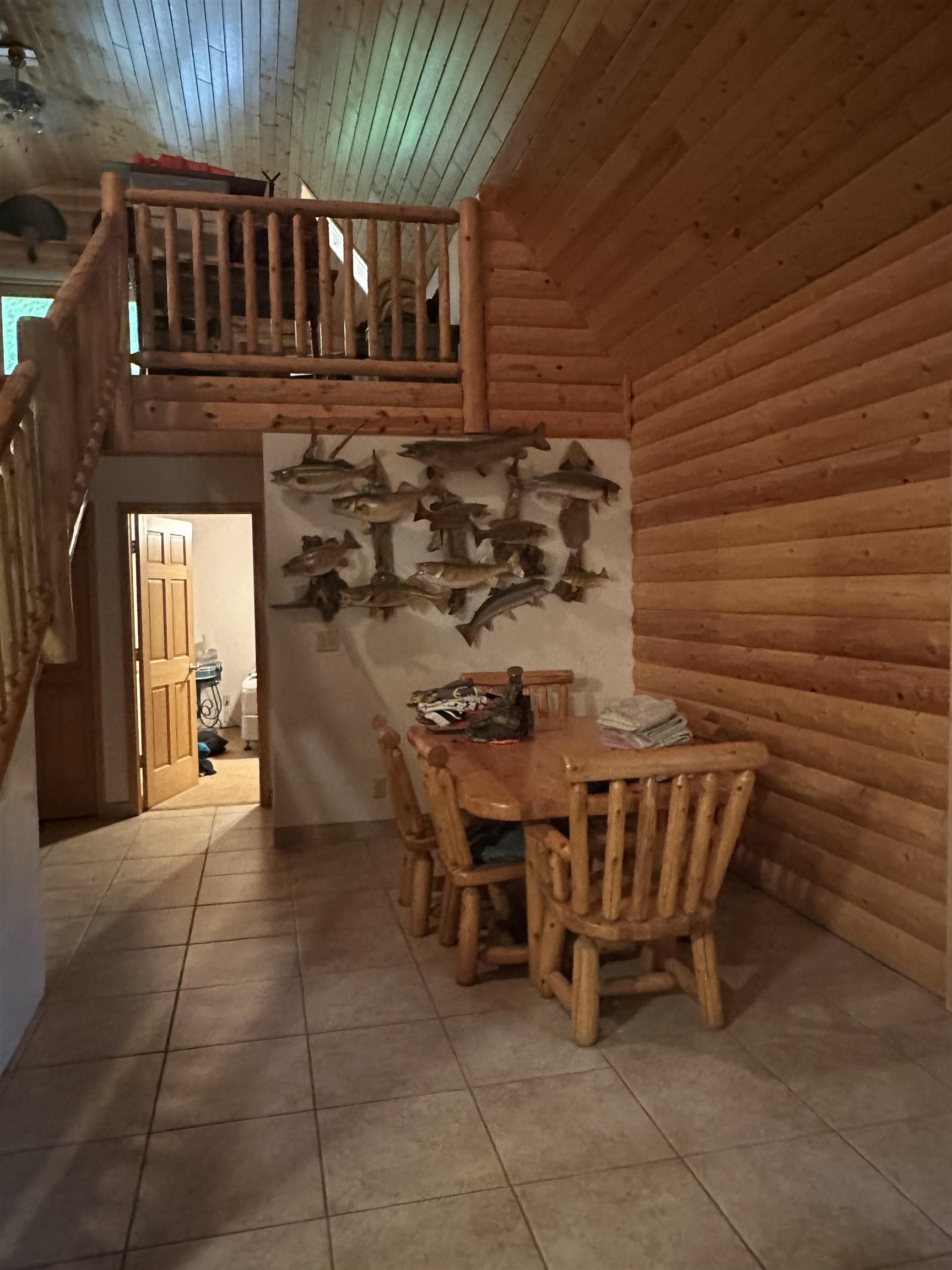 58875 Roy Anderson Road Mason, WI 54856 - Photo 8 of 26 Dining space with wood ceiling, tile patterned flooring, log walls, and high vaulted ceiling