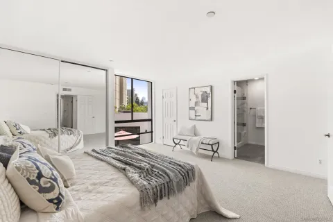 a bedroom with double bed and a large mirror