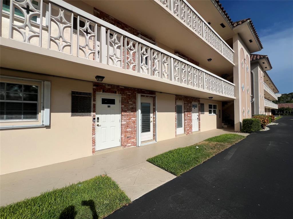a front view of a building with a garden