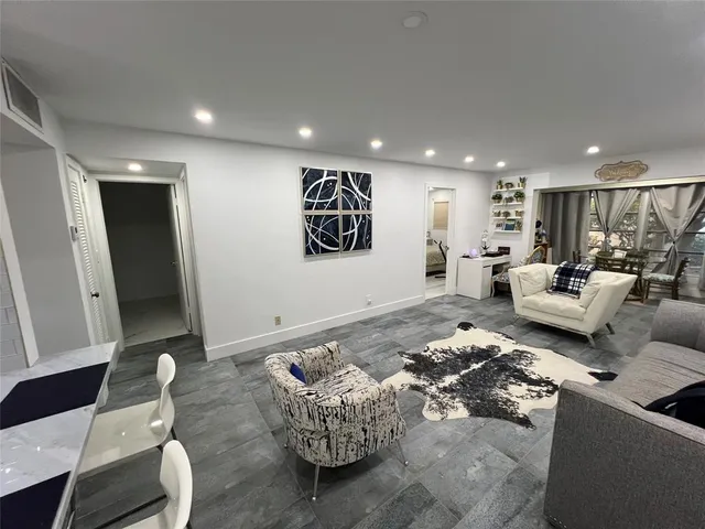 a living room with furniture and a large mirror