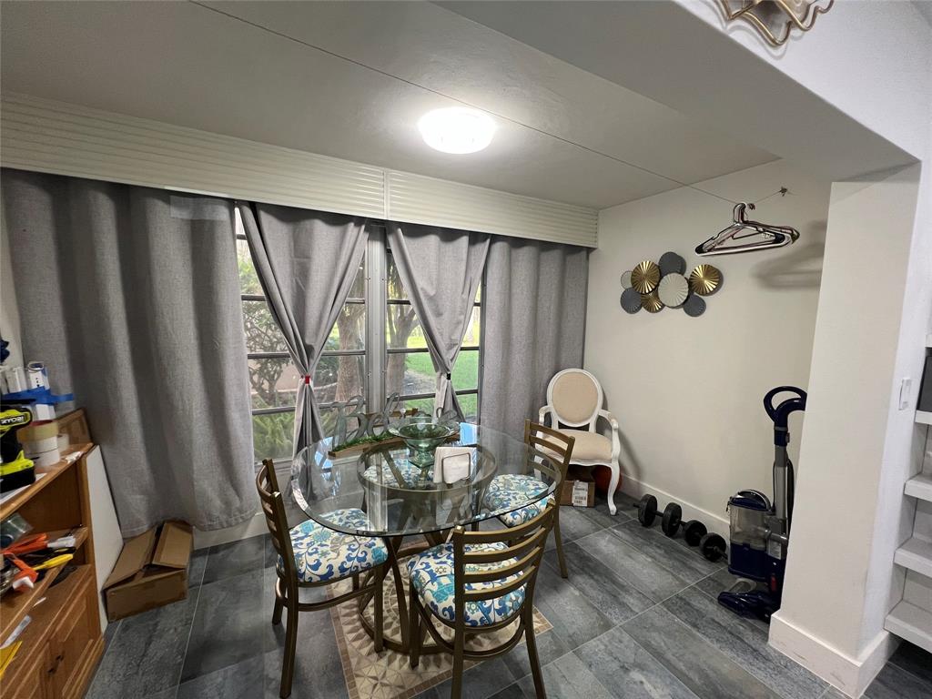 400 Northeast 20th Street, Unit C115 Boca Raton, FL 33431 - Photo 13 of 33 a view of a dining room with furniture window and wooden floor
