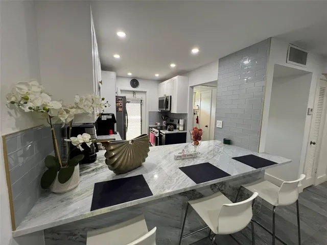 a kitchen with a table and chairs in it