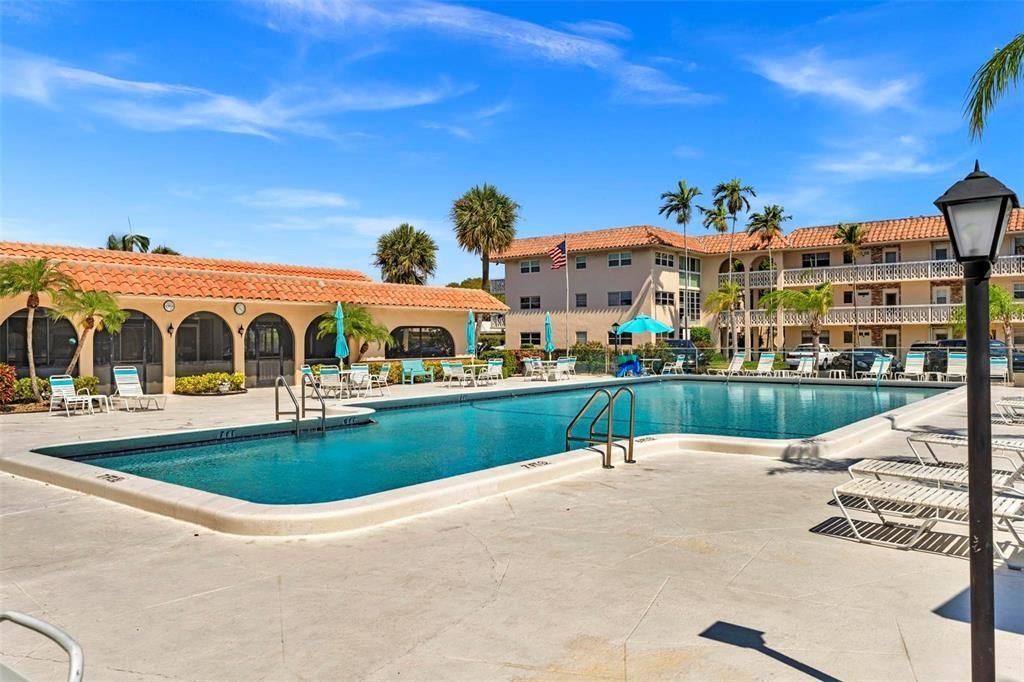 400 Northeast 20th Street, Unit C115 Boca Raton, FL 33431 - Photo 24 of 33 a view of swimming pool with outdoor seating and yard