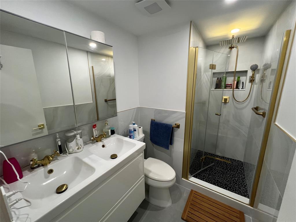 400 Northeast 20th Street, Unit C115 Boca Raton, FL 33431 - Photo 6 of 33 a bathroom with a sink a toilet and shower