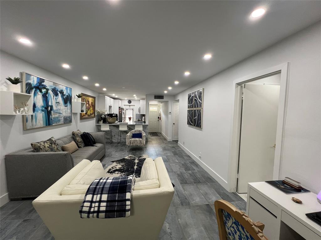 400 Northeast 20th Street, Unit C115 Boca Raton, FL 33431 - Photo 7 of 33 a living room with couches and kitchen view with wooden floor