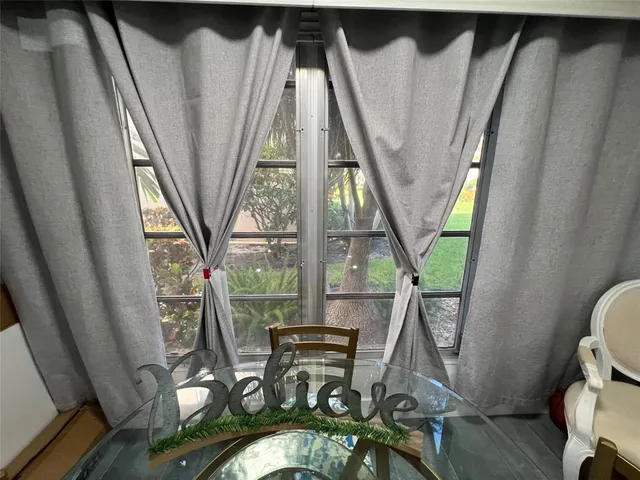 a view of living room with furniture and a floor to ceiling window