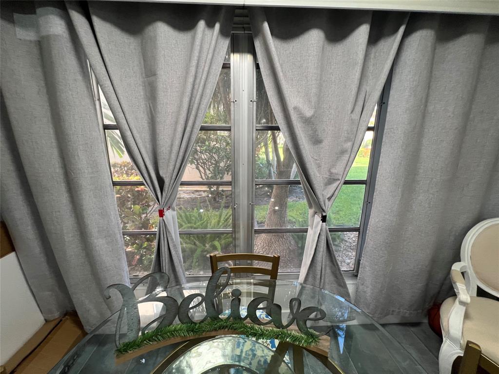 400 Northeast 20th Street, Unit C115 Boca Raton, FL 33431 - Photo 9 of 33 a view of living room with furniture and a floor to ceiling window