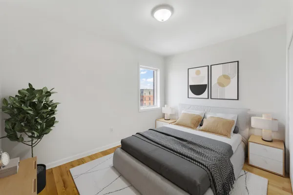 a bedroom with a bed and a potted plant