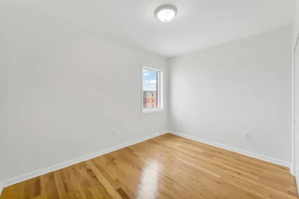 a view of a room with wooden floor and white walls