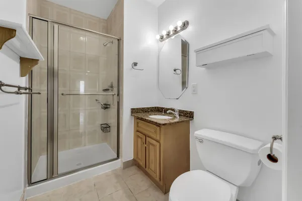 a bathroom with a shower a toilet and a sink