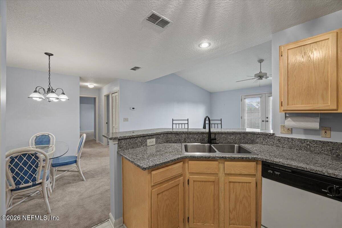 106 Ponte Vedra Colony Circle Ponte Vedra Beach, FL 32082 - Photo 15 of 30 a kitchen with granite countertop a sink and cabinets