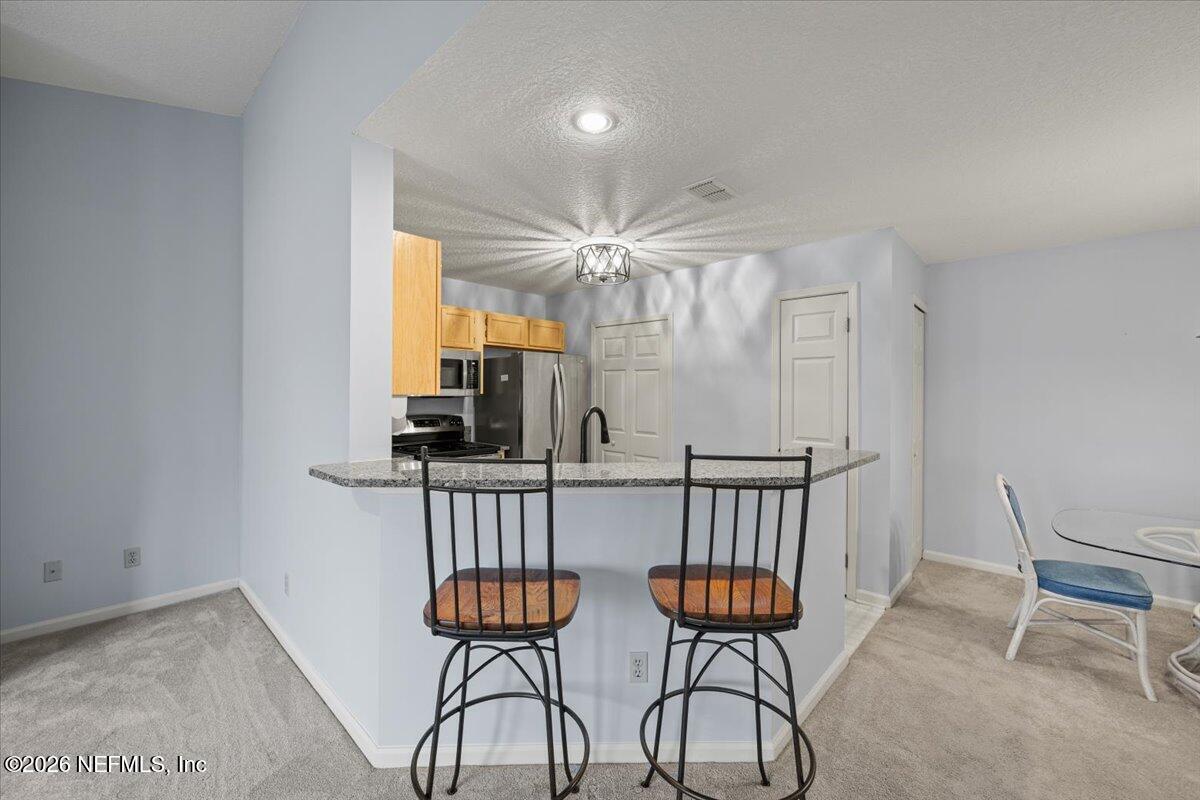 106 Ponte Vedra Colony Circle Ponte Vedra Beach, FL 32082 - Photo 16 of 30 a room with two chairs and a table in a room