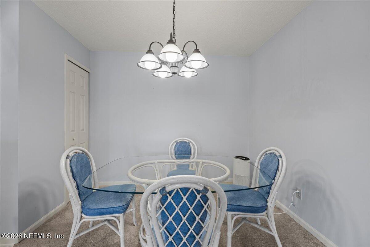 106 Ponte Vedra Colony Circle Ponte Vedra Beach, FL 32082 - Photo 17 of 30 a view of a dining room with furniture window and wooden floor