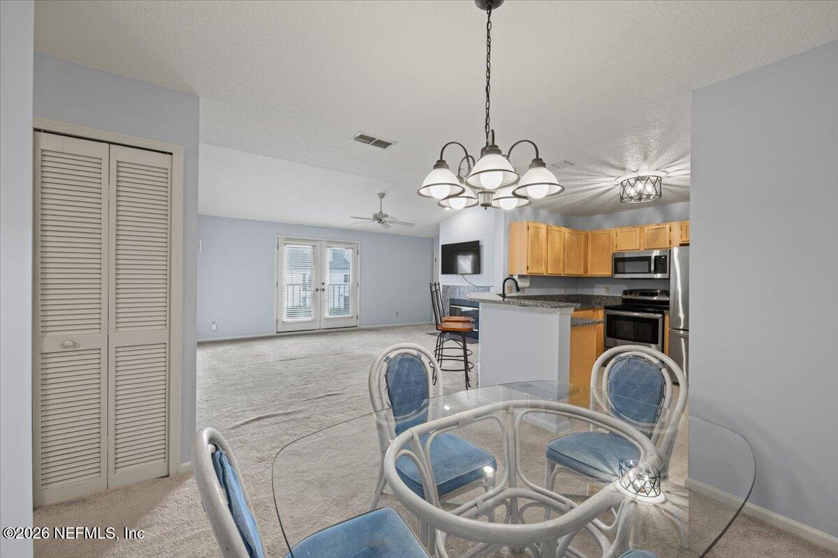 106 Ponte Vedra Colony Circle Ponte Vedra Beach, FL 32082 - Photo 30 of 30 a view of a kitchen filled with furniture and chandelier