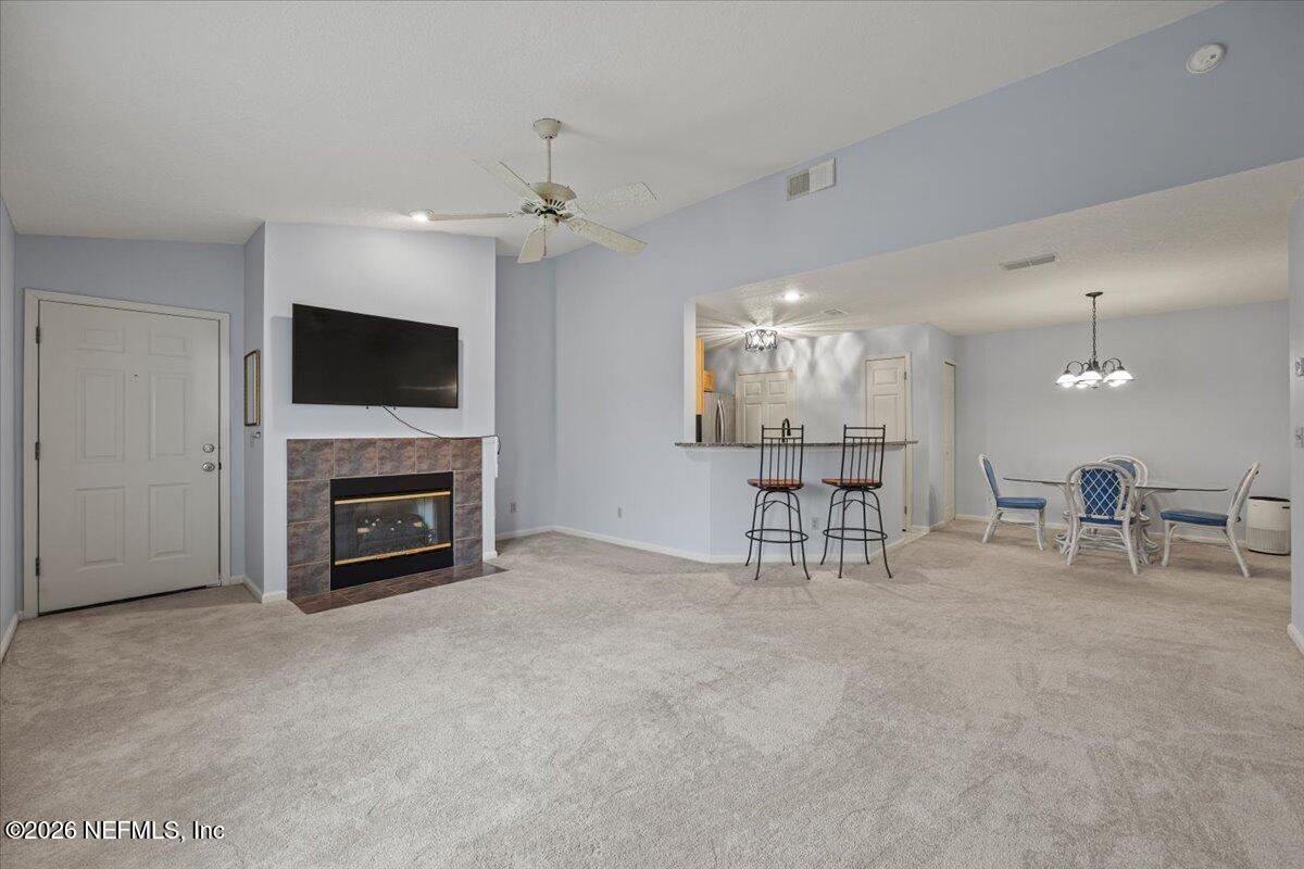 106 Ponte Vedra Colony Circle Ponte Vedra Beach, FL 32082 - Photo 8 of 30 a view of a livingroom with furniture a flat screen tv and fireplace