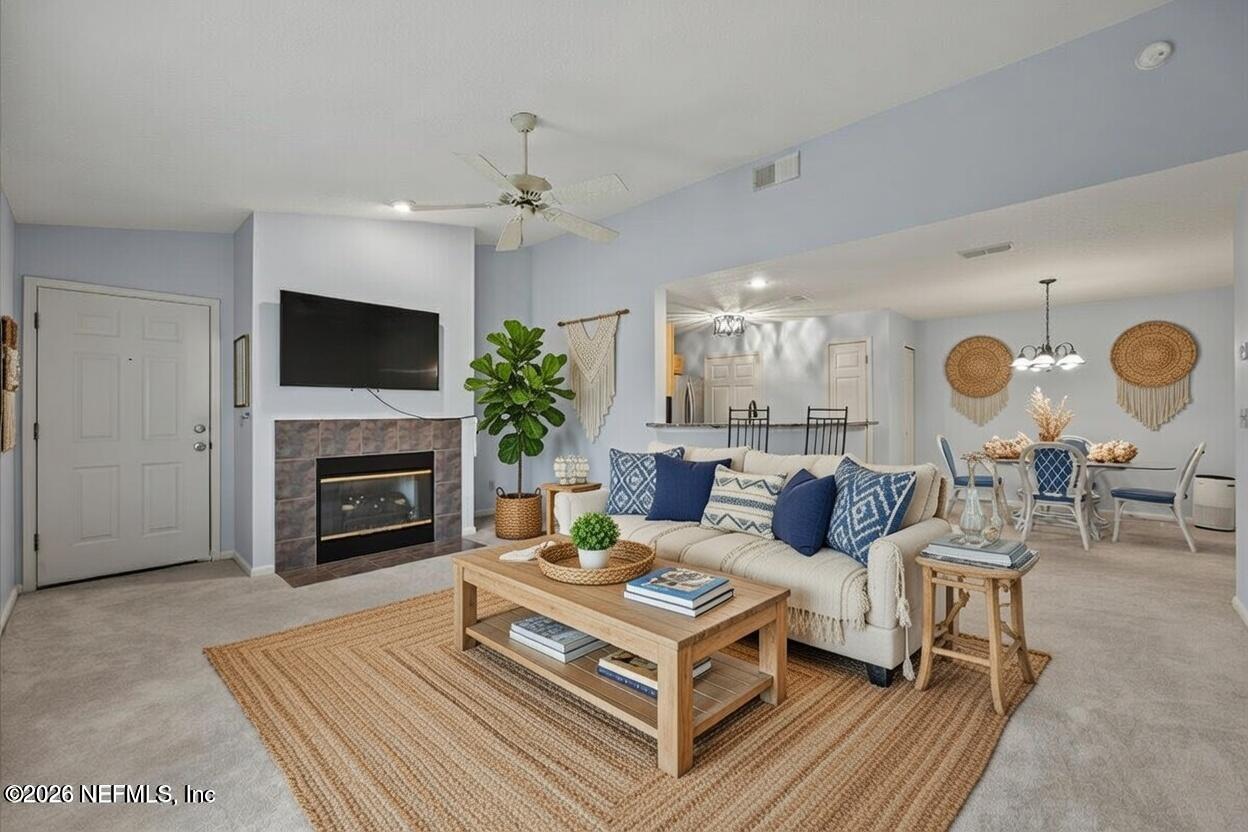 106 Ponte Vedra Colony Circle Ponte Vedra Beach, FL 32082 - Photo 9 of 30 a living room with furniture a fireplace and a flat screen tv