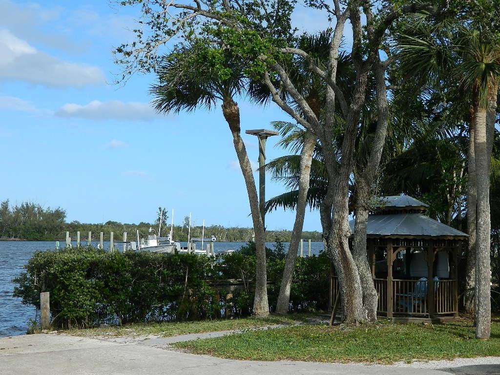 5702 Southeast Hull Street Stuart, FL 34997 - Photo 12 of 12 a view of a house with a yard and potted plants