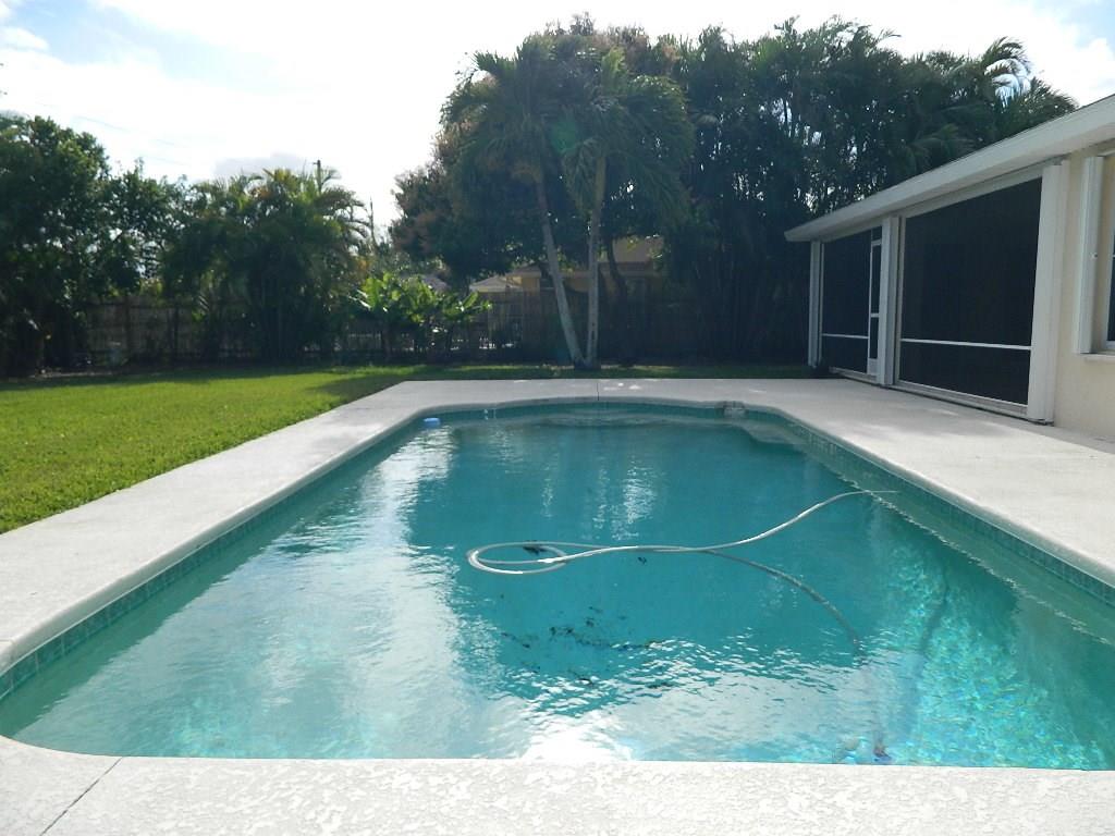 5702 Southeast Hull Street Stuart, FL 34997 - Photo 5 of 12 a view of a swimming pool