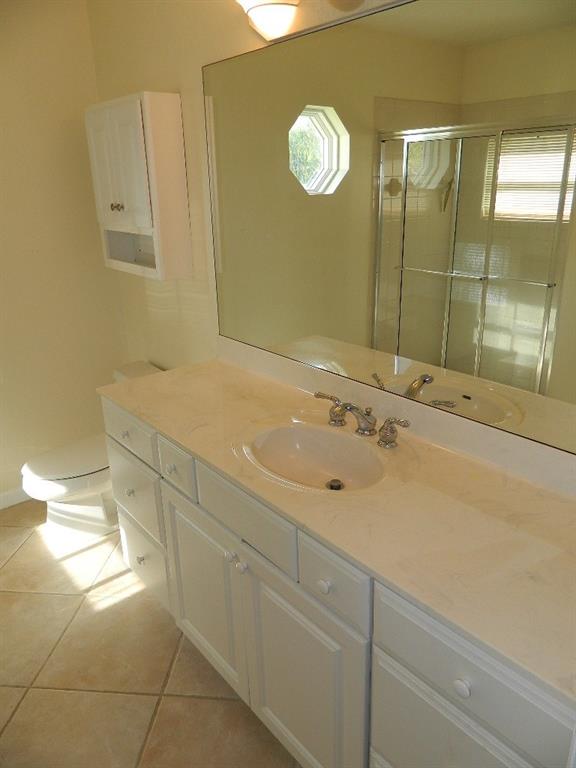 5702 Southeast Hull Street Stuart, FL 34997 - Photo 6 of 12 a bathroom with a sink and a mirror