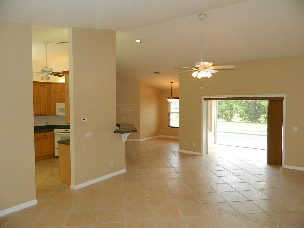 5702 Southeast Hull Street Stuart, FL 34997 - Photo 9 of 12 a view of an empty room with a window