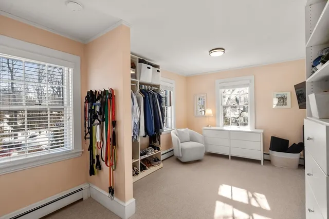 a view of a bedroom with furniture and a window