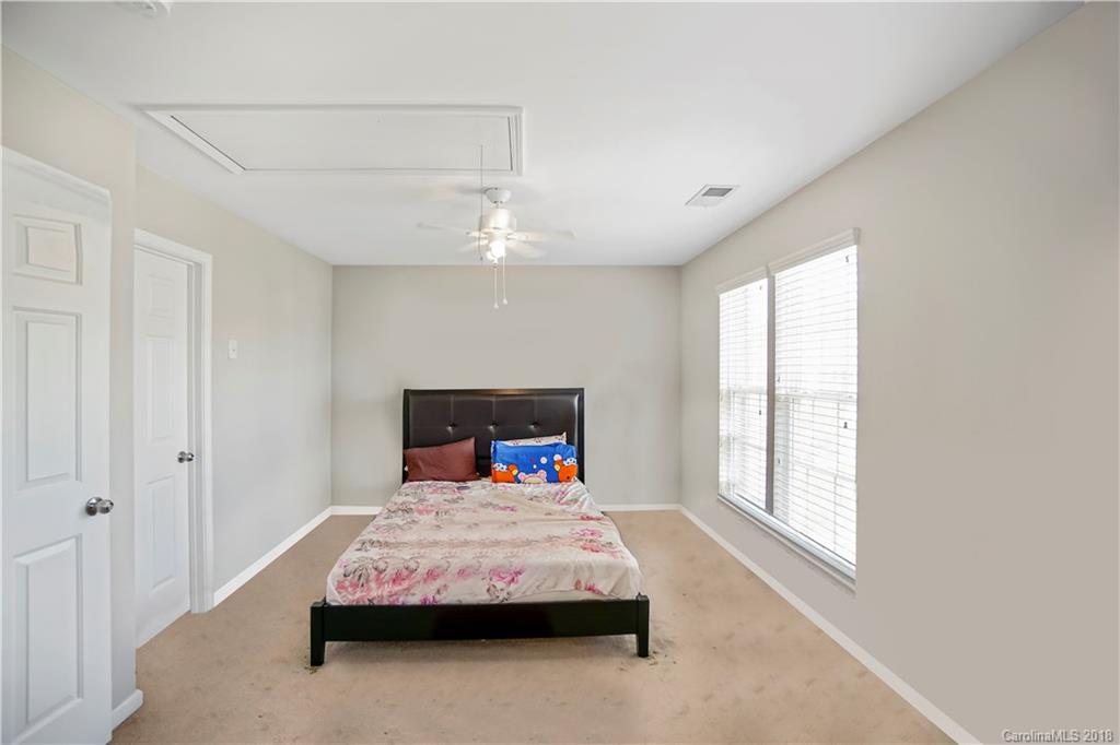 10225 Garrett Grigg Road Charlotte, NC 28262 - Photo 14 of 30 a bedroom with a bed window and a table