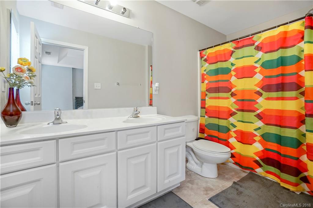 10225 Garrett Grigg Road Charlotte, NC 28262 - Photo 17 of 30 a bathroom with a sink toilet and shower